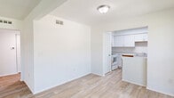 Located at 830 Arlington River Dr in Jacksonville, FL, this single-floor home offers a practical and well-organized layout with two bedrooms, two bathrooms, a combined kitchen and living room, a hallway, and a closet. The living area welcomes natural light through a large window overlooking the outdoors, and features light wood-look flooring that carries a clean, neutral aesthetic throughout the main spaces. The kitchen is outfitted with white shaker-style cabinetry, light-toned countertops, a double stainless steel sink, and white appliances, creating a bright and functional cooking space. A peninsula provides a natural transition between the kitchen and living area. Both bedrooms are carpeted and equipped with ceiling fans, offering a comfortable retreat. The generously sized primary bedroom includes its own closet access. One bathroom features classic white subway tile wainscoting, a vanity with white cabinetry, wood-look flooring, and grab bars, while the second bathroom includes a full tub-shower combination with built-in shelving. A utility closet houses the water heater and additional overhead storage. The overall ambiance is clean, bright, and move-in ready.