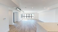 Located on the third floor at 11505 W Olympic Blvd in Los Angeles, this thoughtfully designed unit offers a clean, contemporary aesthetic throughout. The open-concept living and dining area is bright and airy, featuring light wood-style flooring, recessed lighting, and large black-framed windows that invite abundant natural light and offer views of the surrounding cityscape. An exposed spiral ductwork detail adds an industrial touch to the otherwise minimalist design.

The kitchen is a standout feature, showcasing a bold emerald green subway tile backsplash, gray cabinetry extending to the ceiling, stainless steel appliances including a gas range and refrigerator, and a marble-finish peninsula that seamlessly connects to the living area.

The bedroom is carpeted for comfort, finished with crisp white walls, recessed lighting, and sleek black-framed mirrored closet doors. Two well-appointed bathrooms complete the space: one features a glass-enclosed walk-in shower with white tile surround, a wood-tone floating vanity, and an illuminated mirror, while the second offers a clean white countertop, integrated sink, matte black fixtures, and full-width mirror. The unit presents a fresh, move-in-ready environment ideal for modern urban living in West Los Angeles.