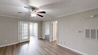 Located at 2410 Allerton Way in Charlotte, NC, this single-story, 3-bedroom, 2-bathroom home offers a well-designed layout with a comfortable and functional living environment. Luxury vinyl plank flooring runs throughout, complemented by neutral beige walls and bright white trim that create a clean, cohesive aesthetic.

The open kitchen and living area serves as the heart of the home, with the kitchen featuring white shaker-style cabinetry, dark granite countertops, a stainless steel sink, and stainless steel appliances including a refrigerator and dishwasher. Crown molding adds a refined touch to the living space, which is equipped with a ceiling fan and connects seamlessly to adjacent rooms.

The primary bedroom is generously sized, accented with crown molding and a ceiling fan. The two additional bedrooms offer natural light through large windows with blinds, and each includes a ceiling fan and closet access. The home includes five closets in total, providing ample storage, along with a dedicated pantry and in-unit laundry area.

Both bathrooms feature tub-shower combinations, dark granite-topped white vanities, and light wood-look flooring. A connecting hallway ties the layout together efficiently. The textured ceilings in select rooms and consistent use of natural light throughout give the home a bright, inviting atmosphere.