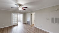 Located at 2410 Allerton Way in Charlotte, NC, this single-story, 3-bedroom, 2-bathroom home offers a well-designed layout with a comfortable and functional living environment. Luxury vinyl plank flooring runs throughout, complemented by neutral beige walls and bright white trim that create a clean, cohesive aesthetic.

The open kitchen and living area serves as the heart of the home, with the kitchen featuring white shaker-style cabinetry, dark granite countertops, a stainless steel sink, and stainless steel appliances including a refrigerator and dishwasher. Crown molding adds a refined touch to the living space, which is equipped with a ceiling fan and connects seamlessly to adjacent rooms.

The primary bedroom is generously sized, accented with crown molding and a ceiling fan. The two additional bedrooms offer natural light through large windows with blinds, and each includes a ceiling fan and closet access. The home includes five closets in total, providing ample storage, along with a dedicated pantry and in-unit laundry area.

Both bathrooms feature tub-shower combinations, dark granite-topped white vanities, and light wood-look flooring. A connecting hallway ties the layout together efficiently. The textured ceilings in select rooms and consistent use of natural light throughout give the home a bright, inviting atmosphere.