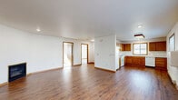 Located at 4532 Arrowhead Dr in Eau Claire, Wisconsin, this single-floor, 2-bedroom, 1-bathroom home offers a practical and comfortable layout with consistent, clean finishes throughout. The open-concept living and kitchen area forms the heart of the home, featuring warm hardwood-style flooring that extends across the main living spaces. The kitchen is well-equipped with solid wood cabinetry, a full suite of white appliances including a range, dishwasher, and refrigerator, and a double-pane window that fills the space with natural light. A large ceiling light fixture adds additional brightness to the kitchen area. The living room is generously sized and includes sliding glass doors that open to the outside, enhancing the sense of openness and providing easy access to natural light. Both bedrooms are carpeted for comfort, with the primary bedroom offering ample space and a sliding closet. The second bedroom features a window with outdoor views. The bathroom includes a full tub/shower combination with a window for ventilation. A dedicated laundry area and an impressive five closets throughout the home ensure excellent storage. Baseboard heating is present throughout, and a wall-mounted gas heater provides supplemental warmth.