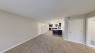 This single-floor, 2-bedroom, 3-bathroom home in Birmingham, Alabama offers a well-designed open-concept layout that seamlessly connects the kitchen and living areas. The kitchen is a standout feature, showcasing rich dark-espresso cabinetry, granite countertops, a peninsula island with pendant lighting overhead, and a full suite of stainless steel appliances including a range, microwave, refrigerator, and dishwasher. Light wood-style flooring runs throughout the kitchen, transitioning to plush carpet in the spacious living room, which receives natural light through a large window. The primary bedroom is generously sized, featuring soft carpet, dual windows with natural light, vertical wall paneling, crown molding, and a ceiling fan. The second bedroom is equally comfortable, with carpet flooring, a ceiling fan, and a bright window. Three bathrooms serve the home, each featuring tiled tub-shower combinations, wood-style flooring, and clean white finishes. One bathroom includes a windowed wall for added natural light. Two hallways and a closet provide practical storage and circulation throughout the home, completing this functional and well-appointed residence.