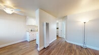 Located at 605 Sorenson Rd in Hayward, California, this single-floor unit offers a practical and clean layout designed for comfortable everyday living. The living area welcomes you with warm wood-style vinyl flooring, neutral-toned walls, and multiple windows fitted with horizontal blinds that allow ample natural light to filter through. A solid front door flanked by windows provides a bright and welcoming entry point.

The galley-style kitchen is efficiently organized, featuring white cabinetry on both sides, a stainless steel sink, a coil-burner electric range, tile backsplash, and a full-size refrigerator. The layout maximizes counter and storage space, making it highly functional. Adjacent to the kitchen is a compact kitchenette-style area with additional white cabinetry and a secondary sink, ideal for supplemental use. A built-in wall heater adds practical climate control to the main living space.

The bedroom is finished with plush carpeting and soft neutral walls, offering a quiet and restful atmosphere. A closet with shelving provides organized storage. The bathroom features a white vanity with under-cabinet storage, a large mirror, and clean, simple finishes throughout. The overall ambiance of the unit is light, neutral, and move-in ready.