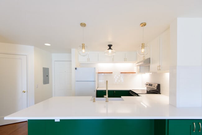 Vintage light fixtures and under-cabinet light make the kitchen bright and cheerful - 2250 NW 58th St
