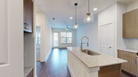 Step into a world of contemporary luxury and effortless living. This exquisite 650 sq ft apartment is a testament to modern design, offering a harmonious blend of form and function. The heart of this urban oasis is the gourmet kitchen, featuring sleek wood cabinetry, high-end stainless steel appliances, and a striking chevron backsplash that adds a touch of sophistication. The expansive island, topped with gleaming granite, serves as both a culinary workspace and a stylish gathering spot.

Natural light floods the open-concept living area through large windows, creating an airy ambiance and offering picturesque city views. Rich hardwood floors flow seamlessly throughout, adding warmth and character. The spacious 150 sq ft bedroom is a serene retreat, complete with plush carpeting and ample closet space for the fashion-forward urbanite.

The bathroom is a spa-like sanctuary, boasting modern fixtures, a generous vanity, and a luxurious shower/tub combination. Energy-efficient lighting and a contemporary ceiling fan ensure comfort year-round. This apartment isn't just a living space; it's a lifestyle upgrade that puts you at the center of Dallas's vibrant Oaklawn neighborhood. Your future of sophisticated city living starts here.