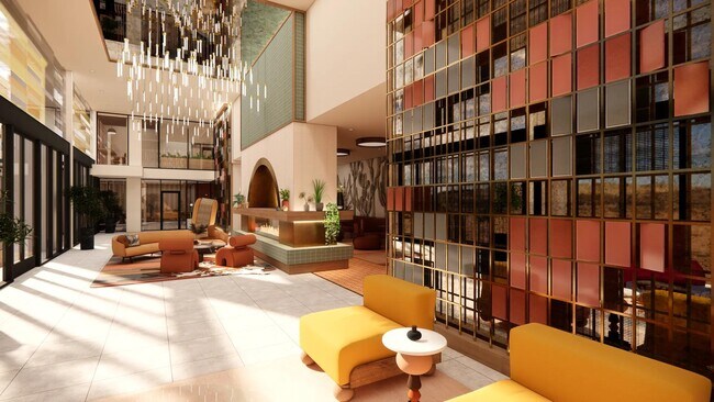 Salón en el vestíbulo con techos de doble altura, chimenea y cómodos asientos. - Modera Rio Salado