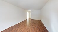 This two-floor space presents a clean, well-maintained interior designed with simplicity and functionality in mind. The rooms are finished with rich, warm-toned hardwood flooring that runs throughout, adding a sense of warmth and continuity to the overall aesthetic. Crisp white walls and smooth ceilings create a bright, airy atmosphere, while natural light filters in through the openings between rooms, enhancing the open and inviting feel of the space. The neutral color palette provides a versatile backdrop, making the interior highly adaptable to a variety of uses and personal styles. The layout flows naturally from one area to the next, with well-defined transitions between rooms that maintain a cohesive and organized feel. The clean lines and unfussy finishes throughout reflect a straightforward architectural approach that prioritizes practicality without sacrificing comfort. Spanning two floors, the space offers ample room for a range of configurations and purposes. The consistent use of quality flooring and neutral wall finishes across the interior gives the space a unified, polished appearance. Overall, this property presents a bright, move-in-ready environment with timeless finishes well-suited to a wide range of occupants.