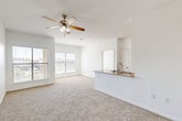 Located at 2104 Canal St in Houston's 77003 zip code, this single-story, 3-bedroom, 2-bathroom home offers a well-designed layout with a comfortable flow throughout. The open-concept living and dining area is anchored by plush carpeting and a ceiling fan, with multiple windows fitted with blinds that invite natural light and offer views of the surrounding neighborhood. A peninsula-style kitchen connects seamlessly to the living space, featuring warm wood cabinetry, granite countertops, a tile backsplash, and white appliances including a range, microwave, dishwasher, and refrigerator. The kitchen is finished with tile flooring and provides access to a dedicated pantry. The bedrooms are carpeted and equipped with ceiling fans, and each benefits from natural light through large windows. The primary bedroom is generously sized with its own dedicated closet space. Both bathrooms are finished with tile flooring, warm wood vanities, granite countertops, and tiled tub-shower combinations. One bathroom features a double-sink vanity. Additional spaces include two hallways, a laundry room, and five closets throughout, ensuring strong storage capacity across the home.