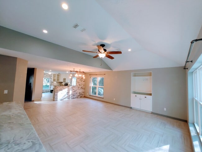 Open spacious living with vaulted ceilings and built-in entertainment center - 2 Arnica Ct