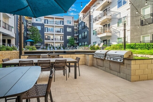 Onsite grill with dining tables and seating - Larq Henderson