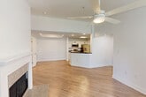 Located at 2750 Millerville Rd in Baton Rouge, LA, this one-bedroom, one-bathroom unit offers a well-designed, single-floor layout that maximizes functionality and comfort. The open-concept living, dining, and kitchen area serves as the heart of the home, highlighted by light wood-style flooring, tray ceilings, and a ceiling fan. A standout tiled fireplace with a classic white mantle anchors the living space, while large windows and a patio door allow abundant natural light and outdoor access. The kitchen features white cabinetry, dark granite countertops, stainless steel appliances including a range, microwave, dishwasher, and French door refrigerator, and a peninsula that provides additional prep and seating space. The bedroom is carpeted and features a tray ceiling, ceiling fan, natural light from a side window, and access to a walk-in closet. The bathroom is well-appointed with a white vanity, matte black fixtures, tile-surround soaking tub and shower combination, and wood-style flooring. Additional features include a dedicated laundry area, multiple closets for generous storage, a hallway, and an entrance foyer, rounding out this efficient and attractively finished Baton Rouge residence.