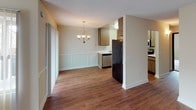 This single-floor residence at 5711 Water Street, Unit #38 Lap, in La Mesa offers a practical and comfortable layout across a well-defined floor plan. The main living area greets you with rich wood-look flooring, neutral-toned walls, and a textured ceiling that runs throughout the common spaces. A dark wood entry door anchors the living room, which provides an open and airy atmosphere with ample room for furnishings.

The dining area flows naturally from the living space, highlighted by an elegant chandelier that adds a decorative touch. Wainscoting detail along the lower walls gives the dining and kitchen transition zone a refined character. The kitchen is equipped with wood-toned cabinetry extending to the upper and lower sections, light countertops, a stainless steel sink, a dishwasher, an electric range, and a microwave — offering a full suite of appliances for everyday cooking.

The bedrooms feature soft, neutral carpet and large windows dressed with vertical blinds, allowing natural light to filter in while offering views of the surrounding greenery. Each bedroom provides a calm, restful environment with clean walls and generous floor space.

The bathroom includes a marble-patterned countertop with an undermount sink, a wood-framed mirror, and a clean, functional layout. Throughout the unit, the consistent use of warm neutral tones and practical finishes creates a cohesive and inviting living environment.