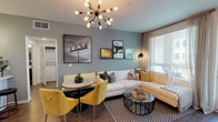 Located at 200 W Pomona Ave in Monrovia, California, this single-story residence offers a well-designed layout with contemporary finishes and a cohesive modern aesthetic. The open-concept living and dining area serves as the heart of the home, featuring warm hardwood-style flooring, a striking sputnik chandelier, and cool gray accent walls. Large windows allow natural light to fill the space, complementing a comfortable sectional seating area and a compact dining nook with vibrant yellow accent chairs.

The kitchen is outfitted with rich dark espresso cabinetry, white quartz countertops, a textured tile backsplash, and stainless steel appliances, including a gas range, microwave, and refrigerator. Pendant lighting and wood-style flooring complete the polished look.

The space includes multiple bedrooms, each featuring plush carpeting, ceiling fans, and generously sized windows dressed with layered curtains that invite soft natural light. The primary bedroom connects to a well-appointed en-suite bathroom featuring a long double-sink vanity with dark cabinetry and wood-style flooring. An additional bathroom offers a full soaking tub with classic white subway tile surround. Throughout, the design balances clean, modern lines with warm, inviting tones.