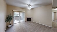 Located at 3601 S Lake Mary Rd in Flagstaff, Arizona, this single-floor, 3-bedroom, 2-bathroom residence offers a well-organized and functional layout. The living room serves as the heart of the home, featuring a tile-surround corner fireplace, plush carpeting, a ceiling fan with light fixture, and sliding glass doors with vertical blinds that open to an outdoor balcony, allowing natural light and greenery views to fill the space.

The kitchen is designed for practicality, featuring warm wood cabinetry, a wraparound laminate countertop with a breakfast bar peninsula, a double sink, electric range, built-in microwave, and tile flooring. Track lighting and a pendant light provide focused illumination throughout the space.

The generously sized primary bedroom includes dual windows overlooking lush outdoor surroundings, soft carpeting, and a ceiling fan. It is accompanied by a walk-in closet outfitted with multiple shelving rails for organized storage. The additional bedrooms are carpeted and equipped with ceiling fans, offering comfortable, well-lit spaces.

Both bathrooms feature tile flooring, vanities with countertop sinks, and full tub-shower combinations with curved curtain rods. Warm neutral tones throughout the residence create a cohesive and inviting atmosphere.