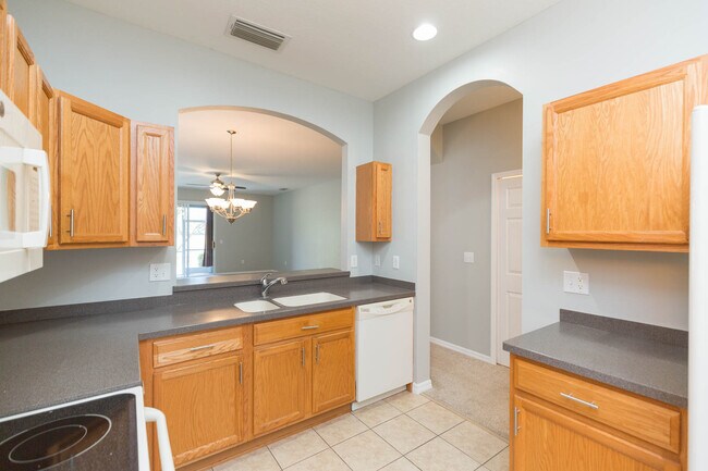Plenty of cabinetry in kitchen with view into great room - 18135 Nassau Point Dr Townhome