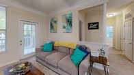 Located at 2101 21st St SE in Hickory, NC, this single-floor residence offers a thoughtfully designed layout with two bedrooms, two bathrooms, and a seamlessly connected living, dining, and kitchen area. The living room features crown molding, a ceiling fan, and a glass door that fills the space with natural light and provides outdoor access. The kitchen is equipped with light wood cabinetry, dark granite-style countertops, a breakfast bar, and white appliances, opening conveniently toward the dining area. The dedicated dining room stands out with elegant wainscoting panels, crown molding, and a pendant light overhead, adding a refined touch to everyday meals. The spacious primary bedroom includes carpet flooring, a ceiling fan, and multiple windows overlooking greenery, paired with an en-suite bathroom featuring a tub-shower combination with tile surround. A second bathroom with hardwood-style flooring offers a shower with a tub. Both bathrooms include vanities with ample storage. The warm, neutral color palette throughout creates a cohesive and welcoming ambiance, making this residence a comfortable and functional home in Hickory, North Carolina.