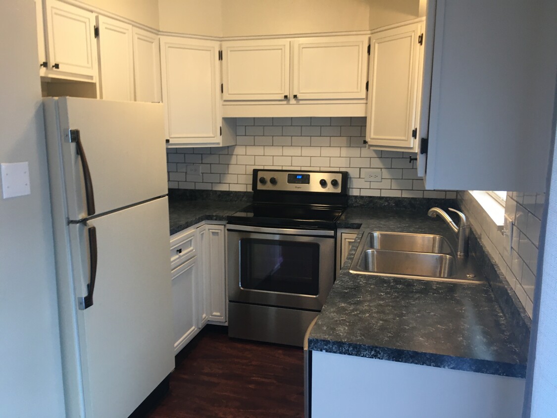 Stainless Steel Appliances with subway tile backsplash - 4715 SE Adams Blvd