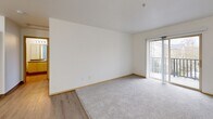 Located at 4317 NE 66th Ave in Vancouver, WA, this one-bedroom, one-bathroom unit offers a thoughtfully arranged single-floor layout. The combined living and dining area is a welcoming open space featuring light wood-style flooring that transitions into plush gray carpet, creating a comfortable and cohesive feel. Sliding glass doors with vertical blinds lead to a private balcony, allowing natural light to fill the room and providing pleasant outdoor views. The kitchen is positioned adjacent to the living area and features warm wood-toned cabinetry, offering functional storage and prep space. The bedroom is a comfortable, well-proportioned room with soft carpet flooring, a large window that brings in natural light and frames a tree-lined view, and a baseboard heating unit. Two closets provide ample storage throughout the unit. The bathroom includes a full tub-shower combination with a clean surround and wood-style flooring. Additional practical features include an in-unit laundry area, making everyday living convenient. Throughout the unit, clean white walls, wood-toned trim, and consistent flooring choices create a bright, neutral aesthetic that is easy to personalize.