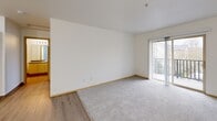 Located at 4317 NE 66th Ave in Vancouver, WA, this one-bedroom, one-bathroom unit offers a thoughtfully arranged single-floor layout. The combined living and dining area is a welcoming open space featuring light wood-style flooring that transitions into plush gray carpet, creating a comfortable and cohesive feel. Sliding glass doors with vertical blinds lead to a private balcony, allowing natural light to fill the room and providing pleasant outdoor views. The kitchen is positioned adjacent to the living area and features warm wood-toned cabinetry, offering functional storage and prep space. The bedroom is a comfortable, well-proportioned room with soft carpet flooring, a large window that brings in natural light and frames a tree-lined view, and a baseboard heating unit. Two closets provide ample storage throughout the unit. The bathroom includes a full tub-shower combination with a clean surround and wood-style flooring. Additional practical features include an in-unit laundry area, making everyday living convenient. Throughout the unit, clean white walls, wood-toned trim, and consistent flooring choices create a bright, neutral aesthetic that is easy to personalize.