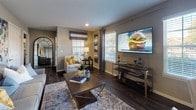 Located at 850 Wilkinson Trce in Bowling Green, Kentucky, this thoughtfully designed single-floor residence offers a cohesive blend of modern finishes and comfortable living spaces. The open living and dining area serves as the heart of the home, showcasing rich dark herringbone-patterned hardwood-style flooring, neutral taupe walls, and multiple windows that invite natural light throughout. An arched entryway connects the main living space to the private quarters.

The kitchen is outfitted with granite countertops, dark cabinetry with brushed nickel hardware, a double-basin stainless steel sink, and stainless steel appliances. A dedicated in-unit laundry area is conveniently accessible directly from the kitchen.

The residence features multiple bedrooms, each finished with plush carpeting and generous closet space. The primary bedroom is distinguished by its deep teal accent wall, tray ceiling detail, and a spacious layout. Additional bedrooms offer neutral tones and ample storage.

The bathrooms echo the kitchen's refined aesthetic, with granite vanity countertops, dark cabinetry, undermount sinks, and wood-look tile flooring. One bathroom includes a glass-enclosed walk-in shower. Throughout the home, consistent finishes and a carefully considered color palette create a polished, inviting atmosphere.