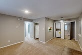 Located at 2600 Houma Blvd in Metairie, Louisiana, this 2-bedroom, 1-bathroom unit offers a practical and well-organized single-floor layout. The open living area features warm beige carpeting, neutral gray walls, and a textured ceiling, creating a clean and understated ambiance. Natural light filters in through vertical blinds and windows, lending a bright feel to the space. A pass-through counter connects the living area to the kitchen, which is equipped with rich wood cabinetry, granite-style countertops, a decorative tile backsplash, hardwood-style flooring, and a white electric range with an overhead ventilation hood. A stackable washer and dryer unit is conveniently housed within the main living area, adding practical in-unit laundry access. The primary bedroom offers a comfortable footprint with plush carpeting, a ceiling fan, and a closet, while the second bedroom also features carpet, a ceiling fan with lighting, a mirrored sliding closet, and a window that brings in natural light. A hallway connects the bedrooms to the shared full bathroom, which includes a tiled tub-shower combination. The unit also includes a dedicated closet for additional storage. Ceiling fans in both bedrooms and a well-connected layout make this a functional and comfortable Metairie residence.