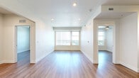 Located at 5880 W Alameda Ave in Lakewood, Colorado, this thoughtfully designed 2-bedroom, 1-bathroom unit offers a clean, modern aesthetic across a single floor. Light-toned hardwood flooring flows consistently throughout every room, creating a cohesive and inviting atmosphere.

The combined kitchen and living area serves as the heart of the unit. The kitchen is outfitted with contemporary light wood cabinetry, a white subway tile backsplash, sleek countertops, and a full suite of stainless steel appliances including a refrigerator, range, microwave, and dishwasher. Track lighting above the kitchen adds both function and style.

Both bedrooms are bright and airy, benefiting from large windows with vertical blinds that allow ample natural light and outdoor views of the surrounding greenery. The primary bedroom includes a ceiling fan, while the second bedroom features a sliding panel closet door for convenient storage. Additional closet space is available within the unit.

The bathroom is finished in a clean, minimalist style with a full tub-shower combination featuring white tile surround, chrome fixtures, and wood-look flooring that ties into the rest of the unit. The overall design is neutral and contemporary, making this a functional and well-appointed space in the heart of Lakewood.