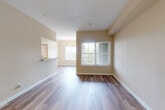 Located at 5751 Wood Meadow Way in Centreville, Virginia, this well-appointed 2-bedroom, 2-bathroom single-floor residence offers a thoughtfully designed layout with a comfortable and functional flow throughout. The open living and dining area is anchored by warm-toned wood-look flooring that extends seamlessly through the main living spaces, complemented by neutral walls and large windows that invite generous natural light. A pendant light fixture accents the dining area, which connects to a private patio — ideal for outdoor relaxation. The kitchen is equipped with rich cherry wood cabinetry, granite countertops, tile flooring, and a full suite of stainless steel appliances including a range, over-the-range microwave, dishwasher, and refrigerator, as well as a convenient pantry. Both bedrooms feature plush carpeting and ceiling fans, with the primary bedroom offering a spacious walk-in closet with built-in shelving. The bathrooms are finished with tile flooring, warm wood vanities, and a tiled tub-shower combination. Additional highlights include three closets, in-unit laundry, a utility room, and hallways that connect all spaces with ease — making this a complete and practical home.