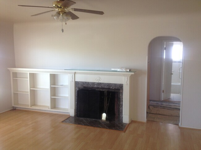 Living room with ceiling fan, wood floors - 2611 W 155th St