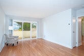 Located at 365 Talbot Ave in Pacifica, CA, this one-bedroom, two-bathroom residence offers a well-organized single-floor layout designed for comfortable, efficient living. Warm hardwood flooring flows consistently throughout the space, lending a cohesive and inviting feel to every room.

The open-concept living and dining area is the heart of the home, bathed in natural light from large sliding glass doors that lead to a private balcony. From the balcony, views of surrounding greenery and the coastal landscape can be enjoyed. The living area offers generous proportions relative to the overall footprint, making it a versatile and airy space.

The kitchen is thoughtfully appointed with white shaker-style cabinetry, quartz countertops, and a full suite of stainless steel appliances, including a range, built-in microwave, dishwasher, and refrigerator — offering both style and functionality.

The bedroom is a well-lit, quiet retreat featuring a window with views of natural foliage and access to ample closet space. The unit includes four closets in total, providing excellent storage throughout. Two bathrooms serve the residence: one features a vanity with a quartz countertop and mirror, while the second includes a full tub-shower combination. Clean, neutral finishes are carried throughout, creating a bright and modern aesthetic.