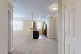 Located at 344 Murray Farm Dr in Fairview, TX, this well-appointed 2-bedroom, 2-bathroom single-story residence offers a thoughtfully designed floor plan that maximizes both comfort and functionality. The open-concept living and dining area is finished with plush carpeting, crown molding, and neutral warm-toned walls, creating a welcoming atmosphere. Multiple windows dressed with blinds allow generous natural light throughout the main living space.

The kitchen is a standout feature, showcasing dark cabinetry with a matching island breakfast bar, dark granite-style countertops, hardwood-style flooring, a tile backsplash, and black appliances including a refrigerator. Pendant lighting above the island and track lighting add both style and practicality.

Both bedrooms are carpeted and feature crown molding and ceiling fans, with the spacious primary bedroom offering a generous walk-in closet with wire shelving. The bathrooms include dark wood vanities with countertop sinks and hardwood-style flooring, with one bathroom featuring a tub/shower combination with tile surround.

Additional highlights include five closets, a dedicated pantry, a utility room, and a full in-unit laundry room equipped with a washer and dryer. The layout is efficient and practical, offering ample storage throughout.