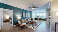Located in Lone Tree, CO, this single-floor residence offers a thoughtfully designed open-concept layout that seamlessly connects the living, dining, and kitchen areas. The living room is a standout space, highlighted by a bold teal accent wall, crown molding, a ceiling fan, and a fireplace, creating a warm yet contemporary atmosphere. Large windows invite generous natural light, enhancing the wood-style flooring found throughout the main living areas.

The kitchen is well-appointed with warm wood-tone cabinetry, white quartz countertops, a subway tile backsplash, and a full suite of stainless steel appliances, including a refrigerator, range, microwave, and dishwasher. A central island provides additional prep and dining space, flowing naturally into a dedicated dining area with convenient access to an in-unit laundry closet equipped with a full-size washer and dryer.

The bedrooms feature plush carpeting, ceiling fans, and large windows that bring in natural light. The bathroom includes a wood-tone vanity with white countertops and a full soaking tub. A walk-in closet provides ample storage. The overall design balances modern finishes with comfortable, functional living.