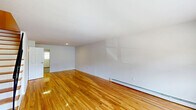 Located at 107 Scenic Dr in Ewing, NJ, this multi-floor home offers a well-organized layout spread across three levels, providing versatile living space throughout. Gleaming hardwood floors are a consistent feature on the main and upper floors, lending warmth and continuity to the interior, while the lower level is finished with durable hard-surface flooring, offering a clean and functional bonus space complete with baseboard heating.

The kitchen stands out as a well-appointed room, featuring rich dark wood cabinetry, granite countertops, a tile backsplash, and a full suite of stainless steel appliances including a gas range, dishwasher, microwave, and refrigerator. A window provides natural light directly into the kitchen area.

Two living rooms offer flexible use — one on the main floor and one on an upper level — both characterized by clean white walls, hardwood floors, and baseboard heating. The spacious primary bedroom includes a closet and connects easily to the upper hallway and staircase. Four closets throughout the home ensure ample storage.

The two bathrooms are cleanly finished: one features a sliding glass shower enclosure and granite-topped vanity, while the other offers a toilet, vanity, and mirror. The lower-level utility space, with exposed infrastructure and painted concrete block walls, provides additional functional square footage. Staircases connect all three floors efficiently.