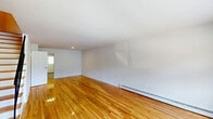 Located at 107 Scenic Dr in Ewing, NJ, this multi-floor home offers a well-organized layout spread across three levels, providing versatile living space throughout. Gleaming hardwood floors are a consistent feature on the main and upper floors, lending warmth and continuity to the interior, while the lower level is finished with durable hard-surface flooring, offering a clean and functional bonus space complete with baseboard heating.

The kitchen stands out as a well-appointed room, featuring rich dark wood cabinetry, granite countertops, a tile backsplash, and a full suite of stainless steel appliances including a gas range, dishwasher, microwave, and refrigerator. A window provides natural light directly into the kitchen area.

Two living rooms offer flexible use — one on the main floor and one on an upper level — both characterized by clean white walls, hardwood floors, and baseboard heating. The spacious primary bedroom includes a closet and connects easily to the upper hallway and staircase. Four closets throughout the home ensure ample storage.

The two bathrooms are cleanly finished: one features a sliding glass shower enclosure and granite-topped vanity, while the other offers a toilet, vanity, and mirror. The lower-level utility space, with exposed infrastructure and painted concrete block walls, provides additional functional square footage. Staircases connect all three floors efficiently.
