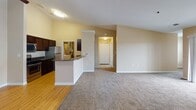 Located on Carronade Drive in Perrysburg, Ohio, this single-floor residence offers a well-designed, open-concept layout that seamlessly connects the main living areas. The kitchen is a functional centerpiece, equipped with dark espresso cabinetry, granite countertops, and a full suite of stainless steel appliances including a gas range, built-in microwave, and refrigerator. Light hardwood flooring runs throughout the kitchen and dining area, transitioning to plush carpeting in the living and bedroom spaces. A peninsula counter separates the kitchen from the adjoining dining area, which features a ceiling fan overhead.

The living room is generously sized with neutral-toned walls and natural light provided by large windows with blinds. The bedrooms are carpeted and well-proportioned, with ceiling fans, ample natural light, and access to spacious walk-in closets outfitted with built-in shelving and organizational systems.

The unit includes two full bathrooms. The first features a full tub-shower combo, tile flooring, and a dark wood vanity with a light countertop. The second bathroom offers a standalone glass-door shower stall, a wide vanity with an oversized mirror, and matching tile flooring. A dedicated utility area houses the water heater and HVAC system, adding practical functionality to the space.