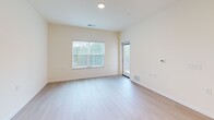 Located at 6822 Shannon Parkway in Union City, GA, this one-bedroom, one-bathroom residence offers a well-designed single-floor layout with a clean, neutral aesthetic throughout. The open-concept kitchen and living area serves as the heart of the home, featuring light wood-style flooring that extends throughout the main living spaces. The kitchen is equipped with light maple cabinetry, granite countertops, a central island for additional prep space and seating, and a full suite of stainless steel appliances including a refrigerator, range, microwave, and dishwasher. Recessed and flush-mount lighting ensures the kitchen is well-lit for everyday use. The living area benefits from large windows dressed with vertical blinds, allowing generous natural light and outdoor views to fill the space. The bedroom is carpeted for comfort and includes its own window for additional natural light. A dedicated walk-in closet off the bedroom provides extensive wire shelving and hanging space for organized storage. The bathroom features a warm wood vanity with granite countertop, tile shower surround, and brushed nickel grab bars, combining practicality with clean design. This residence offers a functional and comfortable living environment.