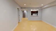 Located at 7147 Woodley Ave in the Van Nuys neighborhood of Los Angeles, this single-floor unit presents a clean, contemporary design throughout. The open-concept living area is defined by light-toned hardwood flooring that runs continuously through the space, complemented by soft gray walls and bright white baseboards that create a fresh, neutral palette. Recessed lighting is installed throughout, providing consistent illumination across all rooms.

The kitchen is accessible via a pass-through window opening from the living area, offering a connected yet defined cooking space. It features high-gloss dark wood cabinetry extending to the ceiling, white quartz countertops, and a full suite of stainless steel appliances including a gas range, built-in microwave, and refrigerator.

The bedroom is a well-proportioned, quiet space with a large mirrored sliding-door closet that reflects natural light drawn in through a sizable window fitted with vertical blinds. The bathroom is finished with cream tile flooring, a dark wood vanity with a white countertop, a large mirror, and a full-sized tub and shower enclosure with sliding glass doors. The overall ambiance is modern, clean, and move-in ready.