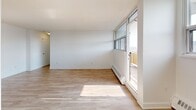 Located at 570 Birchmount Rd in Toronto's Scarborough neighbourhood, this well-appointed 1-bedroom, 1-bathroom unit offers a clean, modern aesthetic throughout. Light-toned laminate flooring runs continuously across the space, complementing the crisp white walls and creating a bright, cohesive feel.

The open-concept living and kitchen area forms the heart of the unit. The living room receives generous natural light through floor-to-ceiling windows and a glass door that opens directly onto a private balcony, offering open views of the surrounding residential neighbourhood. The galley-style kitchen is efficiently designed with white shaker cabinetry, dark countertops, a subway tile backsplash, stainless steel appliances including a refrigerator, stove, and dishwasher, and a deep sink — all arranged to maximize functionality.

The bedroom is a well-proportioned, sun-filled room featuring a window with outdoor views, a baseboard heating unit, and a built-in sliding-door closet providing ample storage. The clean white walls and warm flooring carry through from the rest of the unit.

The private balcony extends the living space outdoors, offering elevated views over the surrounding trees and low-rise neighbourhood. The unit combines practical layout with contemporary finishes, making it a functional and comfortable urban residence.