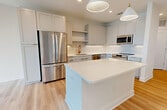This contemporary 750 square foot apartment in Tampa, FL offers a harmonious blend of style and functionality. The open-concept layout maximizes the use of space, creating a seamless flow between rooms. The kitchen is a standout feature, boasting white cabinetry, stainless steel appliances, and a spacious island, perfect for meal preparation or casual dining.

The bedroom, measuring 160 square feet, provides a comfortable retreat with large windows allowing natural light to flood the space. The bathroom is elegantly appointed with a modern vanity, white tile work, and a combination tub-shower.

Practical amenities include an in-unit laundry area with full-sized washer and dryer, and a walk-in closet with built-in shelving for optimal organization. Throughout the apartment, light wood-look flooring adds warmth and continuity.

High ceilings and strategically placed windows create an airy ambiance, while ceiling fans ensure comfortable circulation. The neutral color palette provides a blank canvas for personal decorating styles.

Located at 5301 W Tyson Ave, this unit offers the convenience of urban living with the comfort of a well-designed, modern space. Its efficient layout and thoughtful features make it an ideal home for singles or couples seeking a contemporary lifestyle in Tampa.