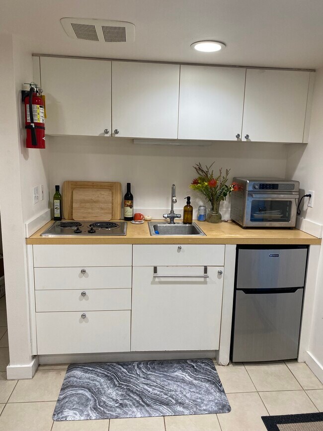 Kitchenette includes fridge, freezer, stove top and convection oven. - 216 W Boston St