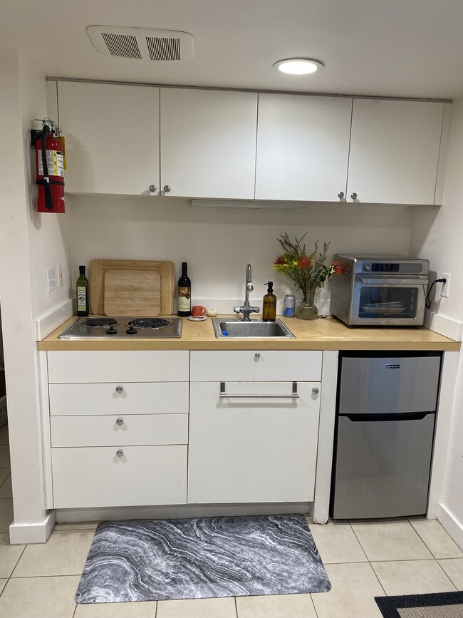 Kitchenette includes fridge, freezer, stove top and convection oven. - 216 W Boston St