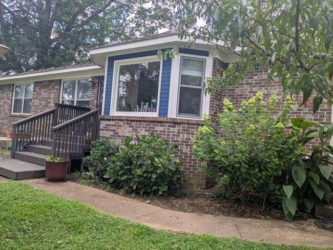 Small deck and paved patio, the shed has a lean-to creating extra shaded recreation space. - 103 Wingfield Dr