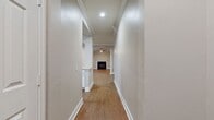 This single-story, 3-bedroom, 2-bathroom home offers 1,310 square feet of thoughtfully designed living space. Warm wood-look flooring flows consistently throughout, complemented by neutral beige-toned walls, crisp white baseboards, and crown molding that lend a polished, cohesive aesthetic.

The kitchen is a standout feature, equipped with white shaker-style cabinetry, granite countertops, a tile backsplash, and a full suite of stainless steel appliances including a range, microwave, dishwasher, and refrigerator. An arched pass-through connects the kitchen to the living areas, which benefit from ceiling fans and open sightlines, creating a bright and airy atmosphere.

The primary bedroom spans 180 square feet and includes crown molding, a ceiling fan, a window with natural light, and access to a private en-suite bathroom featuring a double-sink granite vanity, a soaking tub, and a separate tiled shower. The secondary bathroom mirrors the same refined finishes with a granite vanity and a tub-shower combination.

The two additional bedrooms each include ceiling fans, crown molding, and closets, with one bedroom offering a double-door closet. Two dedicated closet spaces and a laundry room add to the home's practical storage and utility offerings. Three hallways connect the layout efficiently throughout the home.