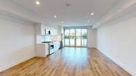 Located at 901 Vine St in the heart of Hollywood, Los Angeles, this modern single-floor residence offers a clean, contemporary design with an open-concept layout that maximizes both space and functionality. Wide-plank hardwood flooring runs throughout the main living area, complementing the crisp white walls and recessed lighting that create a bright, airy atmosphere.

The kitchen is thoughtfully integrated into the living space and features sleek, handleless white cabinetry extending to the ceiling, light-toned countertops, a stainless steel undermount sink, and a full suite of stainless steel appliances including a gas range, over-the-range microwave, dishwasher, and refrigerator. The seamless white tile backsplash adds a polished finishing touch.

The expansive living area is bathed in natural light, courtesy of floor-to-ceiling sliding glass doors that open onto a private balcony, offering open views of the surrounding Los Angeles neighborhood. The bedroom is generously proportioned, featuring recessed lighting, hardwood floors, and closet access.

The bathroom is finished in a modern palette, showcasing a white vanity with an integrated sink, a large wall mirror, and a marble-tiled walk-in shower enclosure, all set against neutral tile flooring. The overall ambiance is clean, minimalist, and move-in ready.