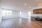Located at 3222 Mission Village Dr in San Diego, CA, this modern 2-bedroom, 2-bathroom residence offers a thoughtfully designed single-floor layout with clean, contemporary finishes throughout. The open-concept living, dining, and kitchen area is anchored by light wood-tone luxury vinyl plank flooring and crisp white walls, creating a bright and airy atmosphere. Large windows flood the space with natural light and frame views of the surrounding neighborhood. A glass-panel door leads directly to a private balcony, seamlessly extending the living area outdoors. The kitchen is well-appointed with warm wood-grain cabinetry, white countertops, a full suite of stainless steel appliances including a refrigerator, range, microwave, and dishwasher, and recessed lighting overhead. Both bedrooms feature plush carpet flooring and generous windows that bring in abundant daylight. The primary bedroom is a comfortable retreat with its own closet. The bathrooms are finished with modern wood-tone vanities, white countertops, large mirrors, and wood-look flooring, maintaining a cohesive aesthetic throughout. Additional conveniences include dedicated closets, a utility room, and in-unit laundry, rounding out this well-equipped and stylish San Diego residence.