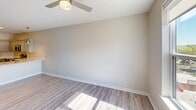 Located at 900 3rd St SE in Cedar Rapids, Iowa, this well-appointed one-bedroom, one-bathroom residence offers a thoughtfully designed single-floor layout that maximizes functionality and comfort. The open-concept kitchen and living area serves as the heart of the unit, where the kitchen stands out with gray shaker-style cabinetry, light quartz countertops, stainless steel appliances including a French door refrigerator, electric range with microwave, and dishwasher, all complemented by light wood-look flooring and recessed lighting. A pendant light adds a refined touch above the workspace. The living area flows naturally from the kitchen, bathed in natural light and finished with the same durable flooring for a cohesive aesthetic. The bedroom is a comfortable retreat featuring plush carpet, a ceiling fan, and a bright window with views of the surrounding urban streetscape. A walk-in closet provides practical storage. The bathroom is clean and functional, offering a tub-shower combination, a gray vanity with a quartz countertop, and matching wood-look flooring. Throughout the unit, neutral warm-beige tones, crisp white trim, and consistent finishes create a modern, move-in-ready atmosphere well-suited for Cedar Rapids urban living.