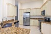 Located in Fort Myers, FL, this well-appointed 3-bedroom, 2-bathroom single-floor home offers a thoughtfully designed layout with generous living space. The kitchen is a standout feature, boasting tall white cabinetry extending to soaring ceilings, granite countertops, light tile flooring, and stainless steel appliances including a side-by-side refrigerator and dishwasher. The open layout connects seamlessly to the dining and living areas, creating an ideal space for everyday living and entertaining. The bedrooms are bright and airy, featuring wood-look flooring, high ceilings, and large windows with blinds that invite natural light. The primary bedroom offers direct access to a private balcony with scenic outdoor views, along with a spacious walk-in closet equipped with built-in wire shelving. The primary bathroom is well-appointed with a soaking tub, separate glass-enclosed shower, granite vanity countertop, and tile flooring. A dedicated laundry room with a utility sink adds everyday convenience. Clean white walls, six-panel doors, and wood-look flooring throughout the hallways contribute to the home's bright, cohesive aesthetic, making this Fort Myers residence a comfortable and functional place to call home.