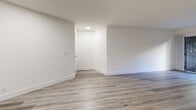 This 630 square foot apartment in Los Angeles offers a thoughtful layout that maximizes space efficiency. The single-floor design encompasses one bedroom, two full bathrooms, and an open-concept living area. The primary bedroom, measuring 140 square feet, includes a closet and provides a comfortable retreat.

The living space showcases modern finishes, with light-toned wood-look flooring extending throughout the apartment, creating a sense of continuity and openness. White walls and ceilings enhance the brightness of the rooms, while recessed lighting fixtures provide even illumination.

The kitchen features sleek white cabinetry paired with contrasting dark countertops and stainless steel appliances, offering both style and functionality. The living room includes a fireplace, adding a cozy touch to the space.

Large windows in the living area and bedroom allow natural light to flood the interior, while also offering views of the surrounding area. The bathrooms are equipped with modern fixtures and finishes, including a bathtub in at least one of them.

Two closets provide ample storage space, helping to maintain a clutter-free environment. The apartment's layout, as seen in the 3D floor plan, demonstrates an efficient use of space, making this compact urban dwelling feel surprisingly spacious and livable.