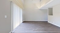 This contemporary residence in Lyndon, Kentucky, offers 1180 square feet of thoughtfully designed living space across two floors. The home boasts two bedrooms, including a spacious 160 square foot primary bedroom, and two full bathrooms. The interior showcases a neutral color palette with light gray walls, creating a bright and airy atmosphere throughout.

The first floor, encompassing 610 square feet, features plush gray carpeting in the bedrooms and living areas, while the kitchen and bathrooms are outfitted with durable wood-look flooring. The modern kitchen is a highlight, boasting sleek white cabinetry, speckled granite countertops, and stainless steel appliances. A convenient in-unit laundry area is seamlessly integrated into the kitchen space.

Ascending to the second floor, which spans 570 square feet, you'll find additional living space with hardwood floors and large windows that flood the rooms with natural light. The bathrooms are elegantly appointed with white vanities, granite countertops, and modern fixtures. 

Throughout the home, recessed lighting and updated fixtures contribute to the overall contemporary aesthetic. The property's layout includes two living room areas, providing ample space for relaxation and entertaining. With its fresh, modern design and convenient location in Lyndon, this home offers a comfortable and stylish living environment.