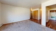 Located at 601 N Hartwell Ave in Waukesha, Wisconsin, this two-bedroom, one-bathroom unit offers a practical and well-organized single-floor layout. The entryway opens through a hallway that connects the main living areas, with hardwood-style flooring running through the common spaces and warm wood trim throughout adding a cohesive, classic touch.

The kitchen is efficiently designed with rich wood cabinetry featuring decorative hardware, light countertops, a double-basin sink, a white electric range, and a stainless steel refrigerator. Hardwood-style flooring continues underfoot, giving the space a clean, functional feel.

Both bedrooms are carpeted and offer comfortable proportions, with natural light provided by windows overlooking the surrounding neighborhood. The primary bedroom includes a large sliding-door closet with warm wood paneling. Baseboard heating runs along the walls in the bedrooms, ensuring year-round comfort. A ceiling fan is present in one of the bedrooms.

The bathroom is a standout feature, showcasing a fully tiled walk-in shower with wood-look tile, brushed nickel fixtures, a vanity with storage, and hardwood-style flooring — giving it a clean, updated feel.

A living area with carpet and a ceiling fan rounds out the layout, with an additional closet and interior doors finished in natural wood tones throughout.