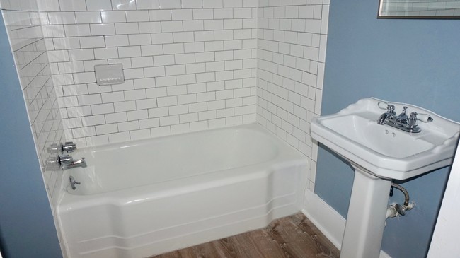 renovated bathroom with tile & pedestal sink - 70 S Cedar St